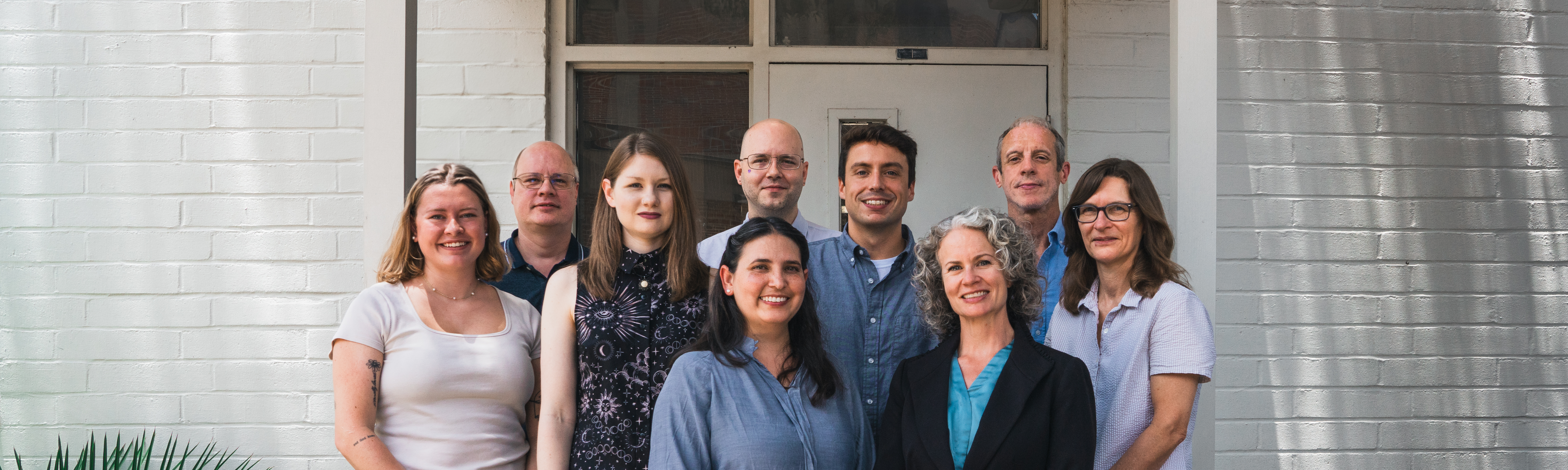 An image of all nine FIRST staff in front of the FIRST building