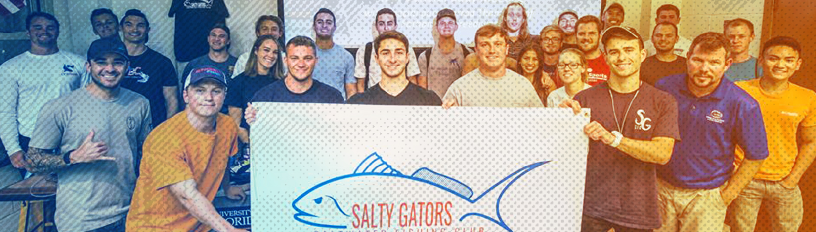 Group of students posing for a photo with the salty gator fishing club banner. 