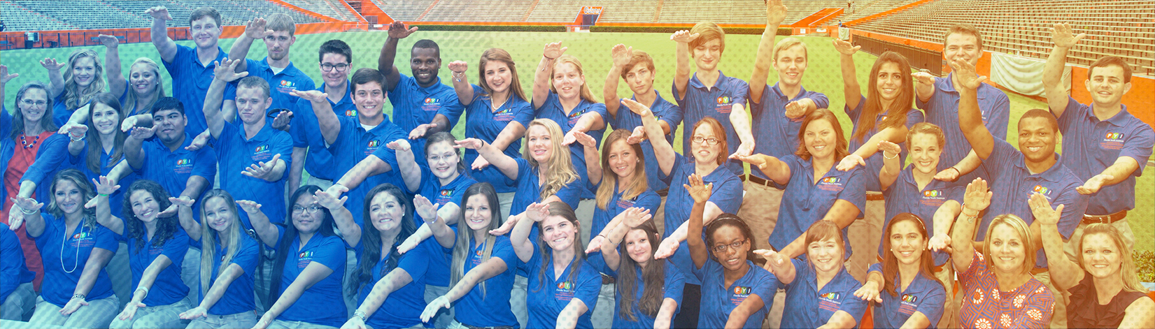 Florida Youth Institute participants and counselors pose wearing blue polos at the UF Ben Hill Griffith stadium.
