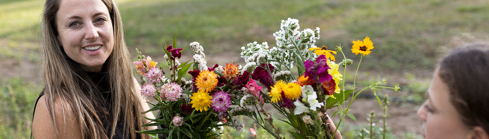 Woman collects a variety of flowers.
