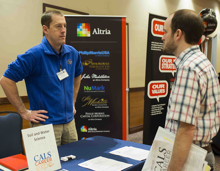CALS advisor available and talking to a student from his booth at a CALS event. 
