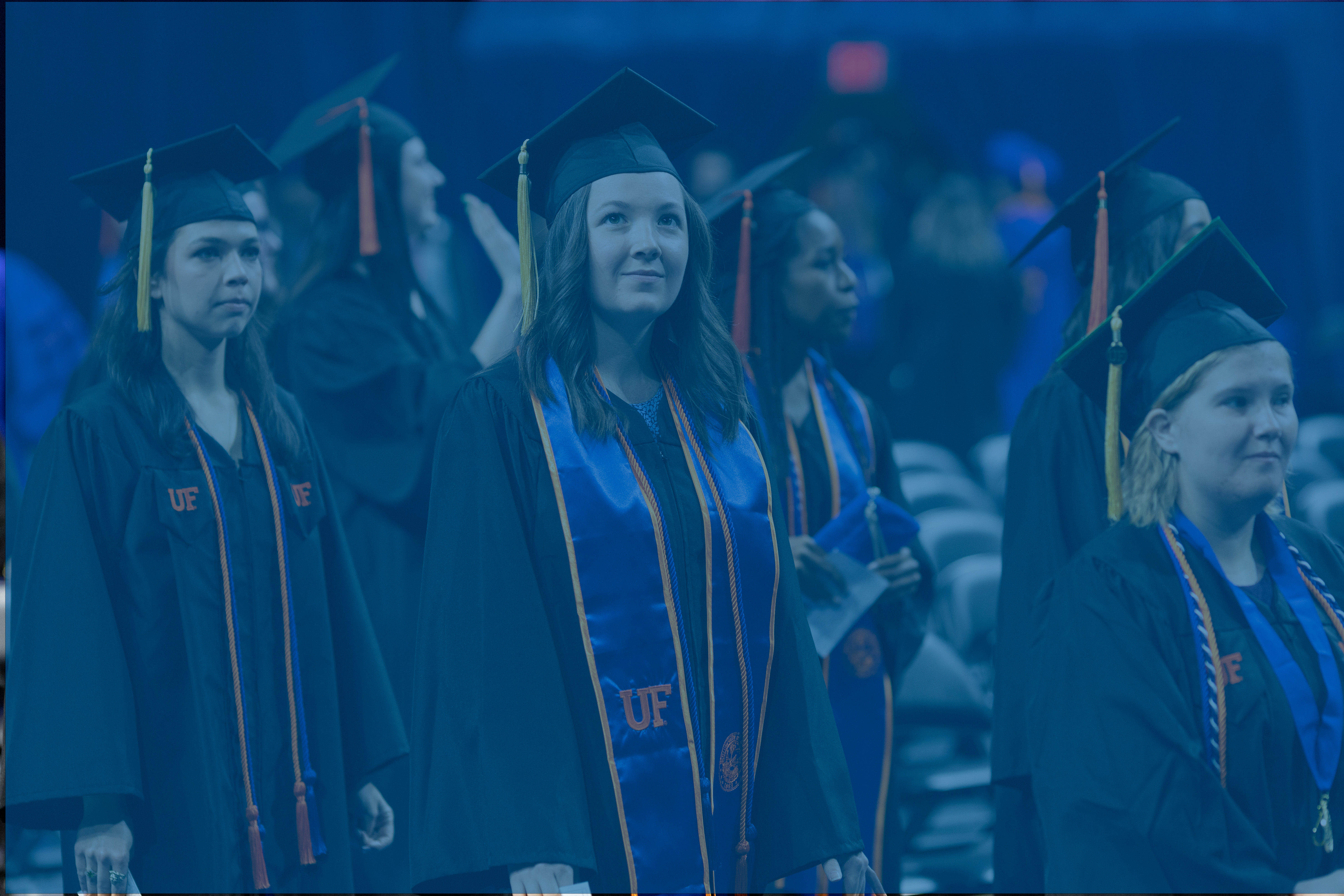 Students standing in cap and gown for a ceremony.